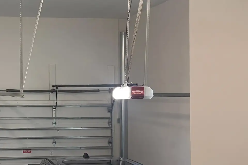 Garage door opener rail and motor unit mounted to the ceiling