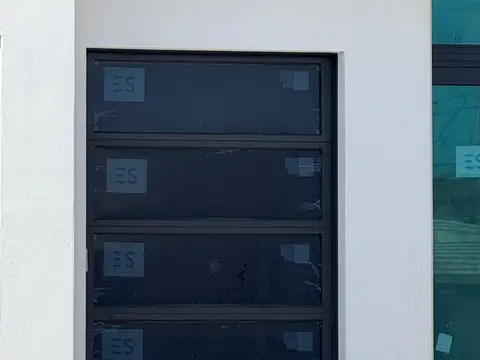 New black full-view glass garage door with the factory protective film still on